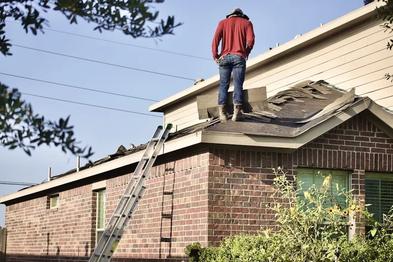 Professional roofer working on a residential roof in El Sereno